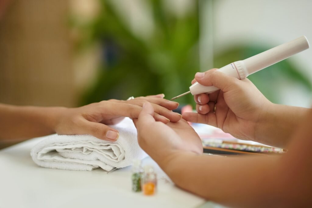 Receiving Relaxing Professional Manicure Treatment Indoors