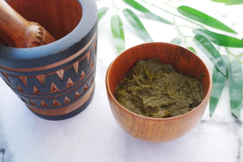 The wooden bowl with rehydrated henna on table
